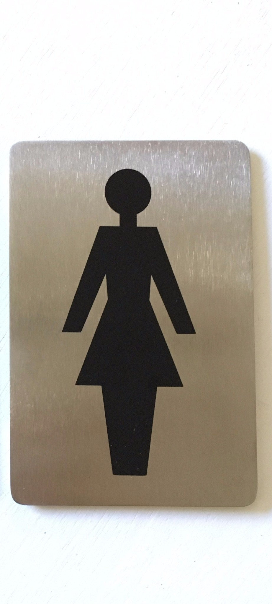 Stainless steel sign with a black female figure symbol