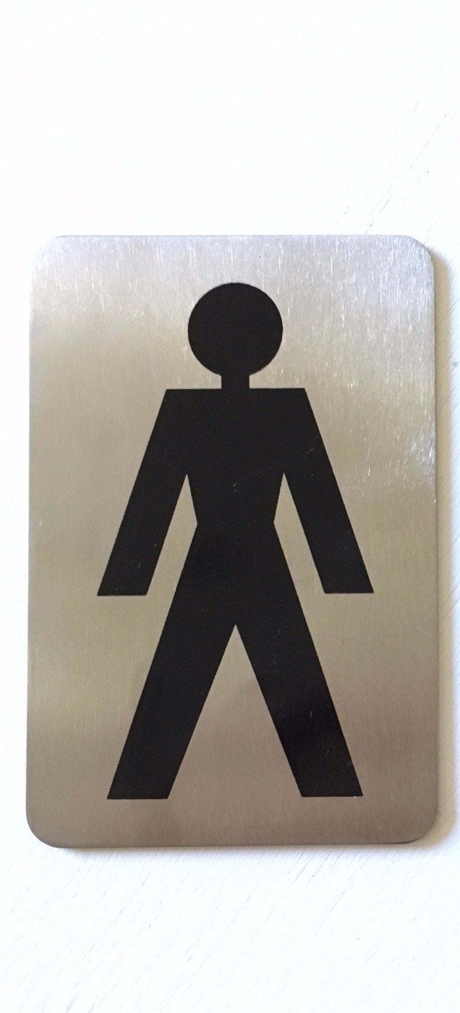 Stainless steel sign with a black male figure symbol