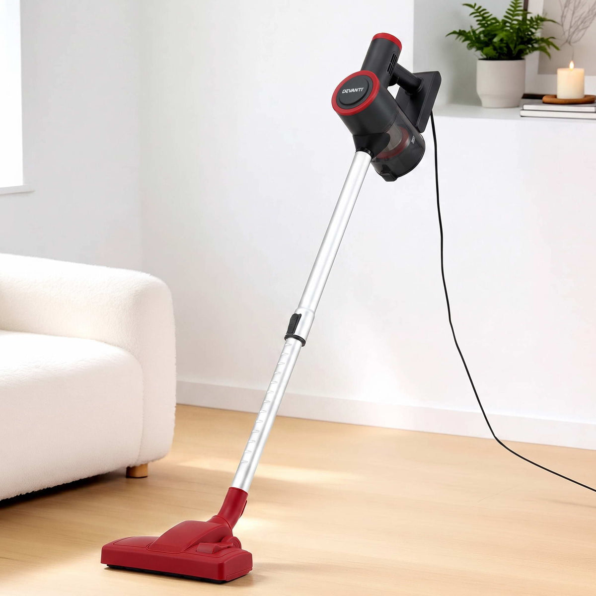 Red stick vacuum cleaner.