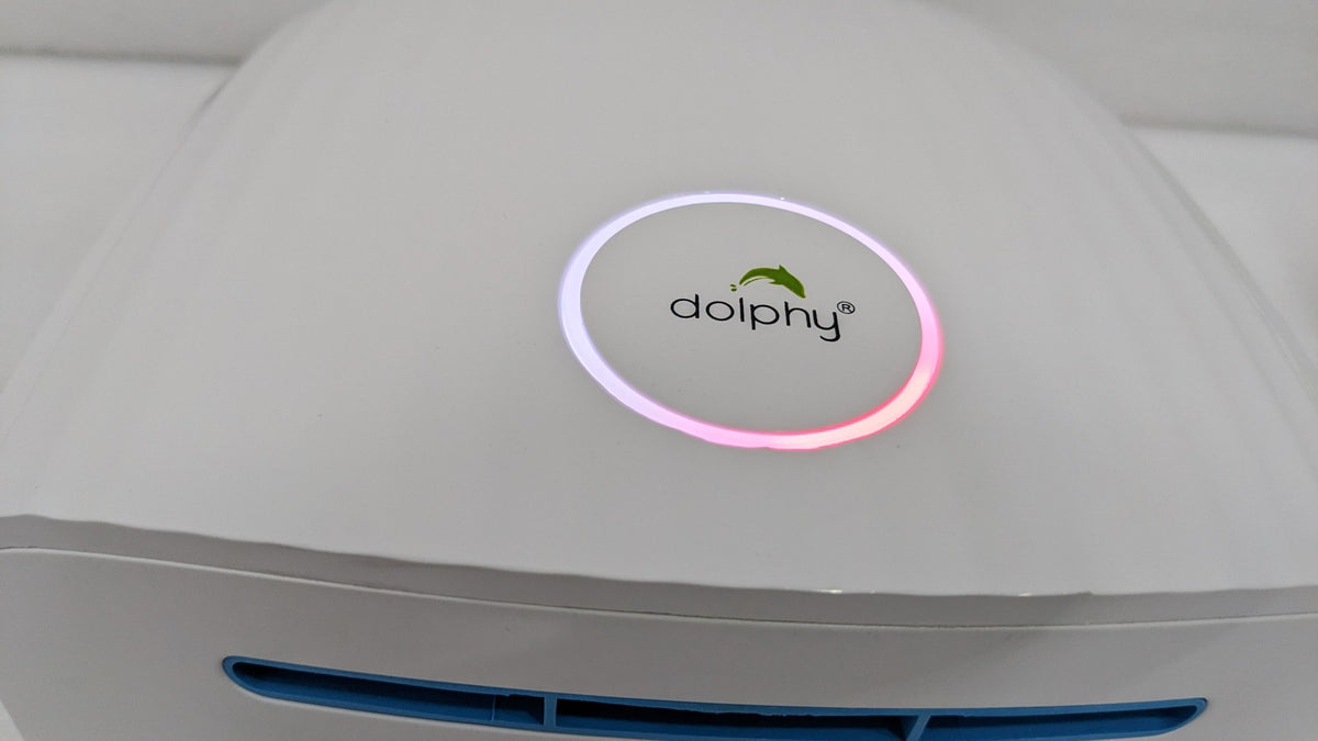 Close-up of the Dolphy logo ring and blue-lit air outlet on the white dome hand dryer