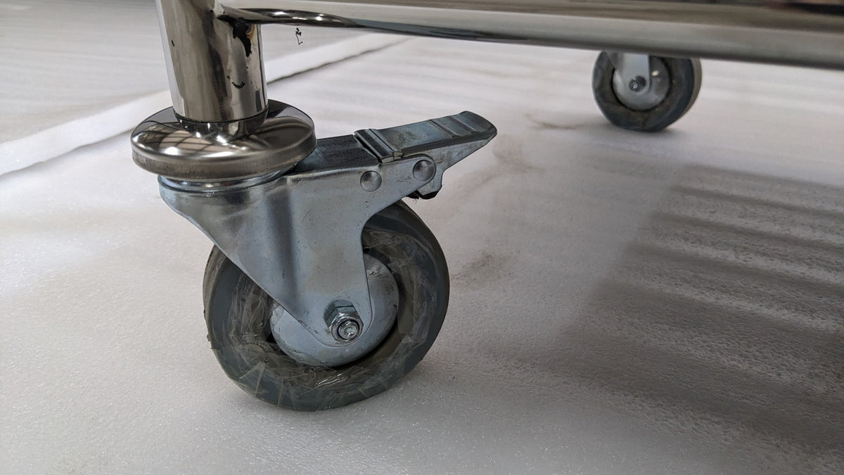 Close-up of a braked castor wheel on the Dolphy laundry cart