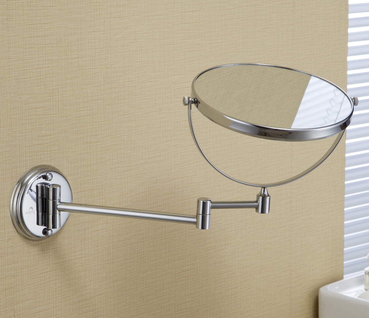 Dolphy chrome magnifying mirror on its wall arm, tilted to show the swivel