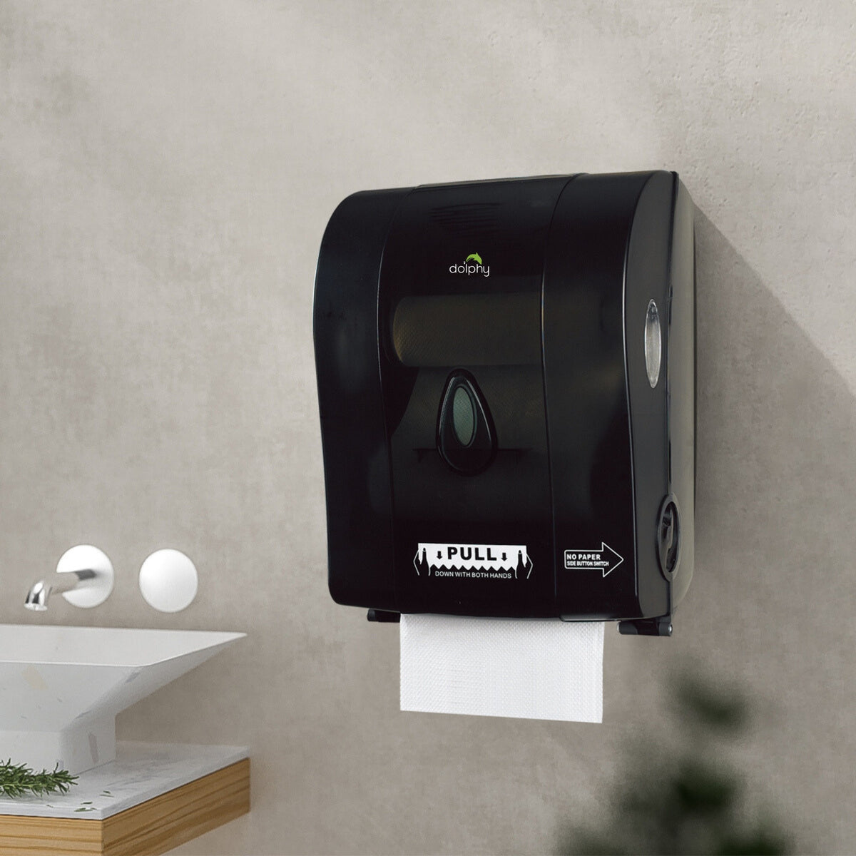 Dolphy black auto-cut paper towel dispenser mounted on a washroom wall beside a basin