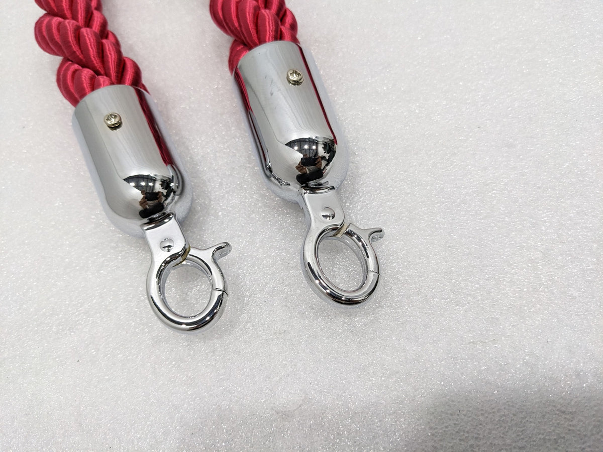 Close-up of the chrome end caps and snap hooks on the red queue rope