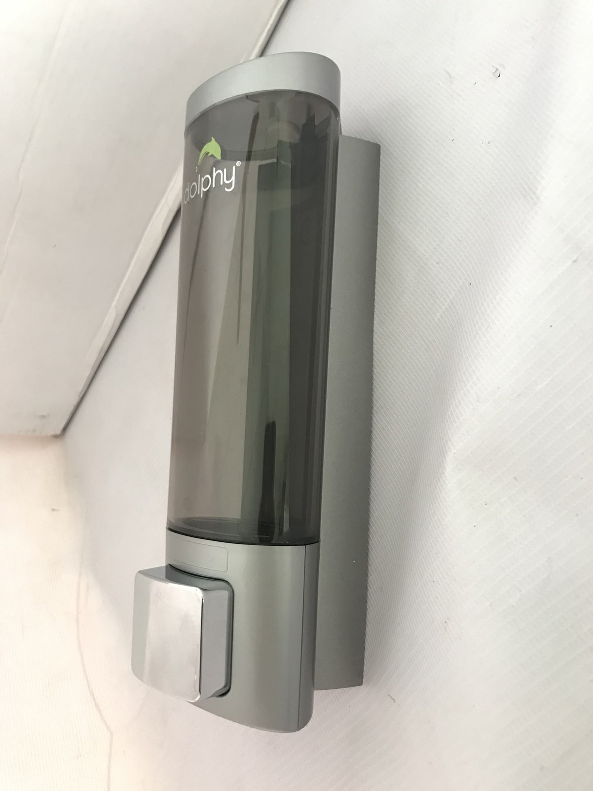 Dolphy 200ml smoked soap dispenser mounted on a wall, side angle