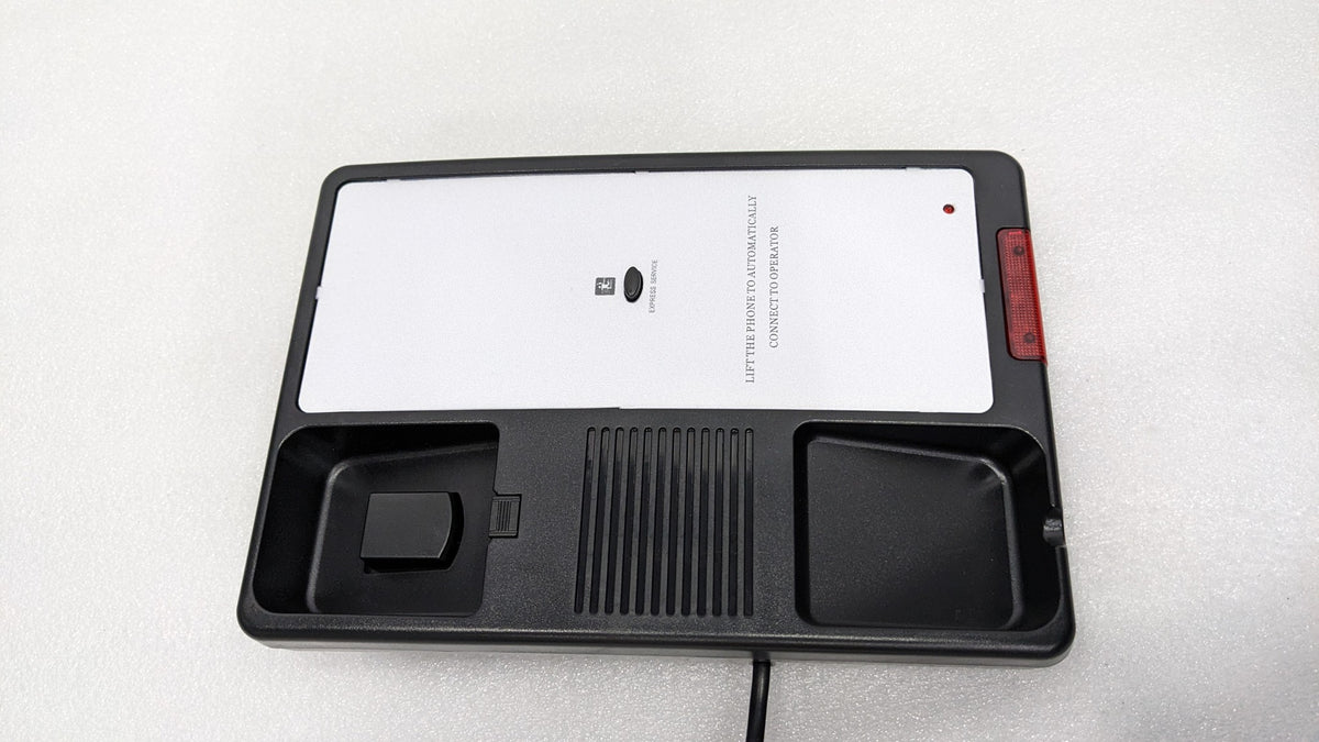 Dolphy black telephone base with the handset lifted, showing the cradle