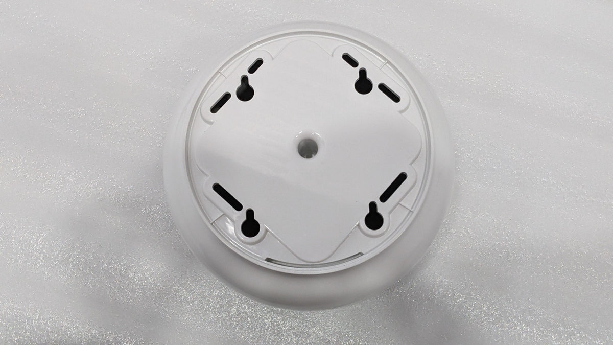 Back of the Dolphy centre-pull dispenser showing the keyhole wall-mount slots