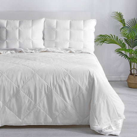 White Bianca 250GSM bamboo summer quilt with a diamond quilted pattern on a made bed