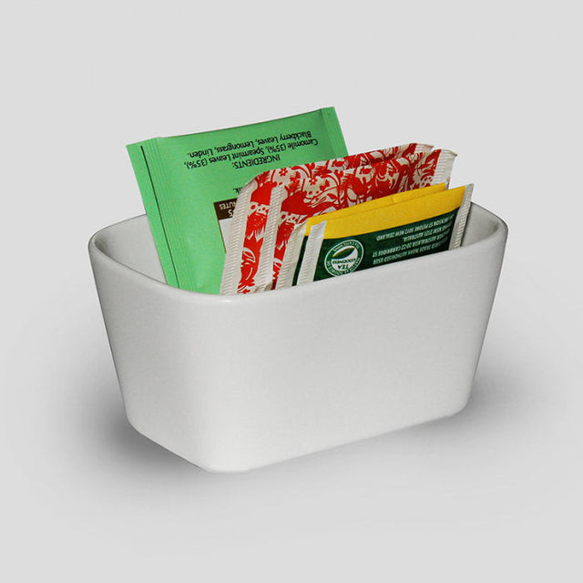 White porcelain sachet holder filled with tea and coffee sachets