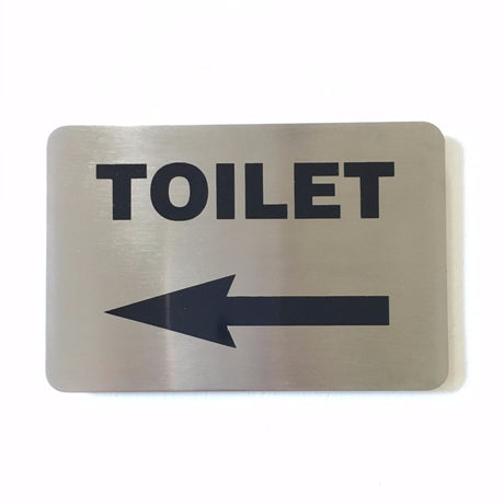 Stainless steel TOILET sign with an arrow pointing left