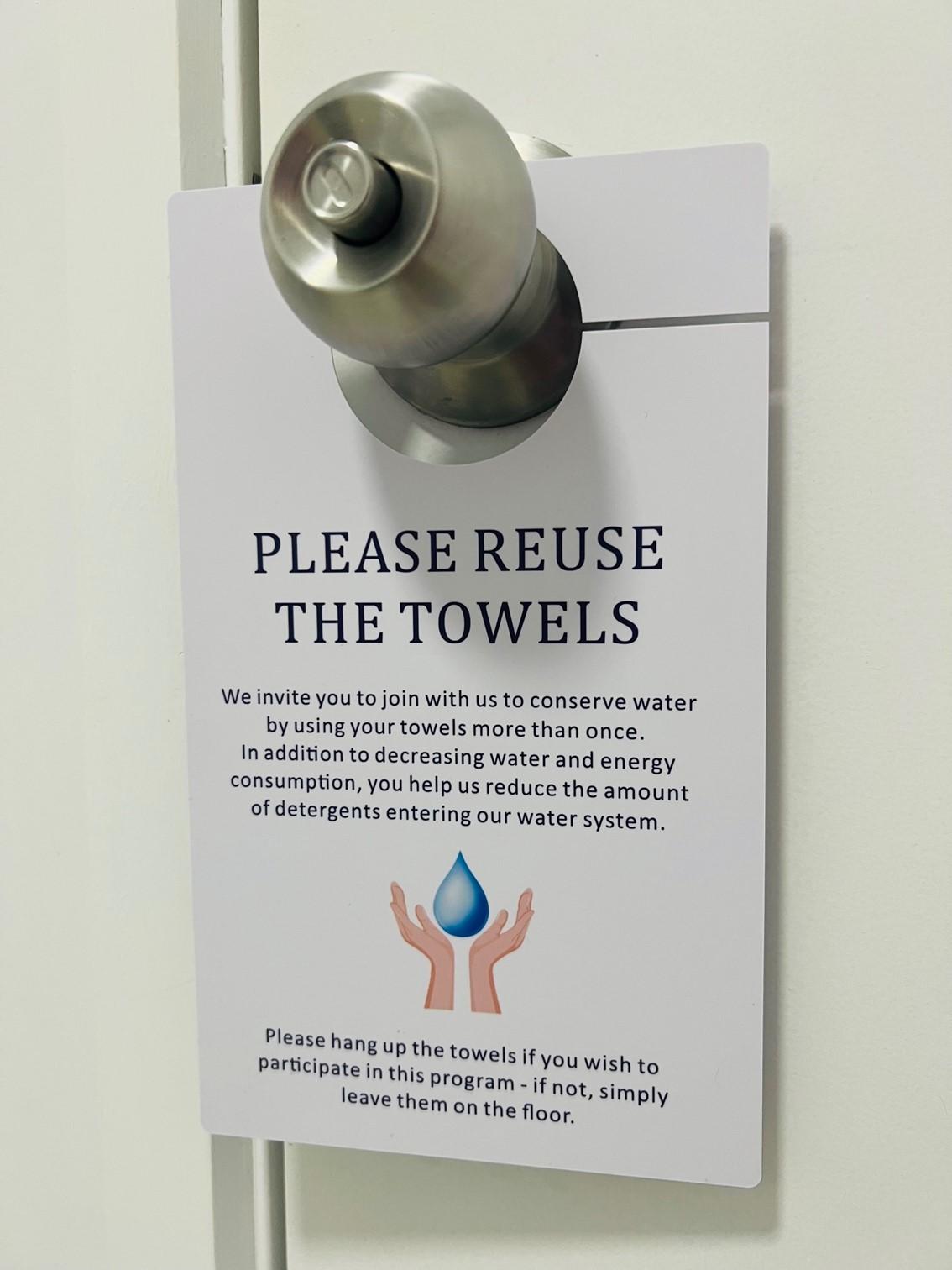 Please Reuse the Towels door hanger hanging on a door handle