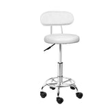 White swivel salon stool, height adjustable.