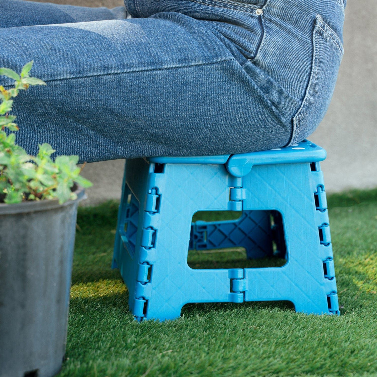 Blue plastic folding chair, with a non-slip base.
