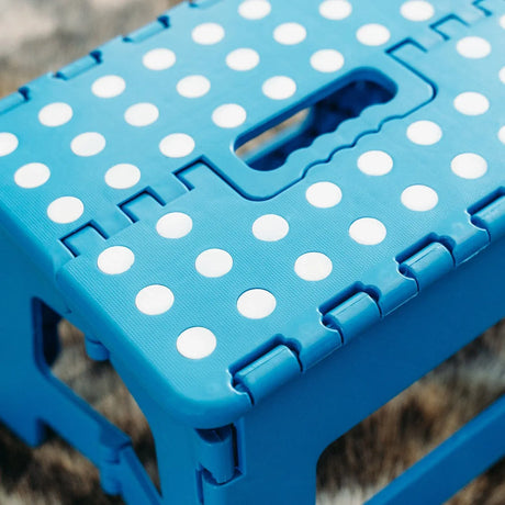 Blue plastic folding chair, with a non-slip base.