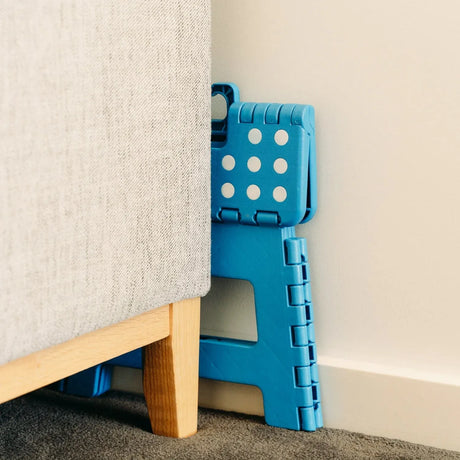 Blue plastic folding chair, with a non-slip base.