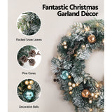 The 60cm snowy LED wreath shown again, for indoor or outdoor use.