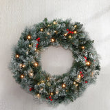 The 60cm snowy lit wreath shown again, arriving pre-lit.