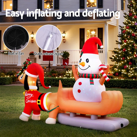 Another view of the inflatable snowman and dog, with pegs and ropes for anchoring.