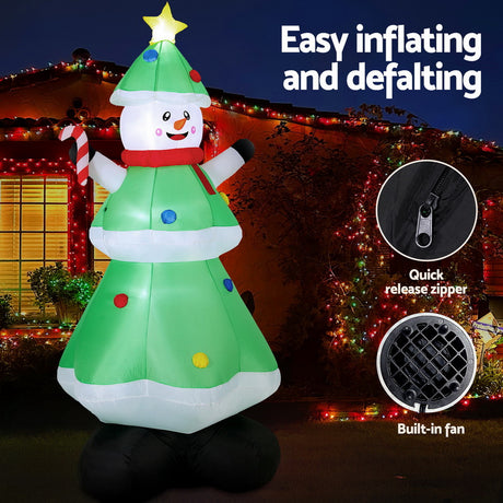 Another view of the inflatable snowman and tree, with pegs and ropes for anchoring.
