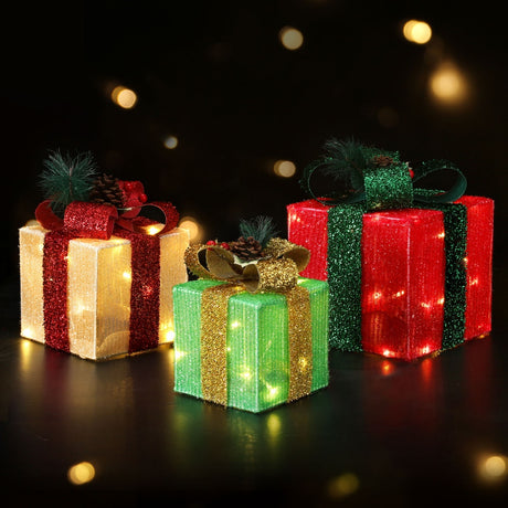 The three lit gift boxes shown again, battery operated.