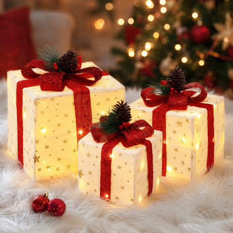 Three lit Christmas gift boxes.