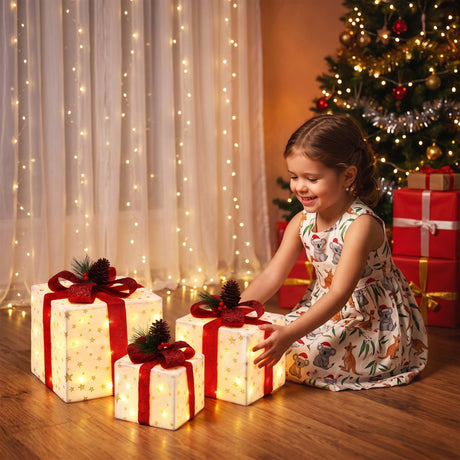 The three lit gift boxes shown again, arriving pre-lit.