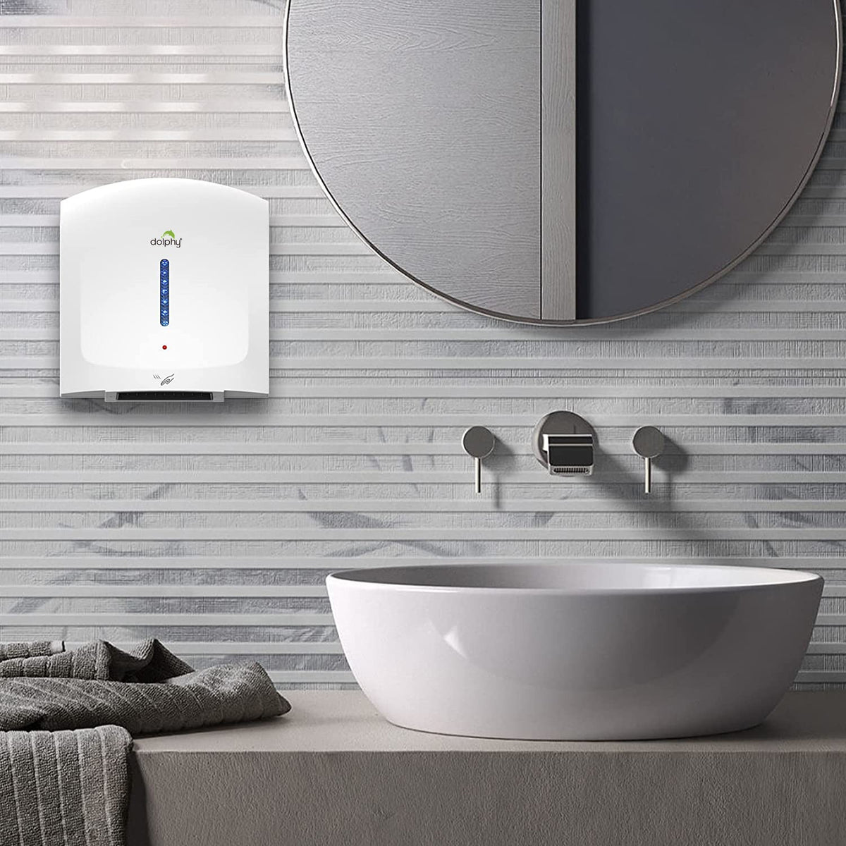 Dolphy white hand dryer mounted on a tiled bathroom wall beside a basin and mirror
