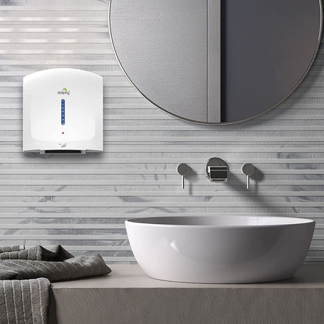 Dolphy white hand dryer mounted on a tiled bathroom wall beside a basin and mirror