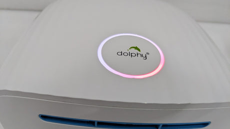 Close-up of the Dolphy logo ring and blue-lit air outlet on the white dome hand dryer