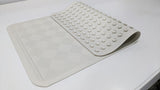 Dolphy rubber bath mat with one end folded back to show the suction cups underneath