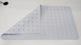 Dolphy bath mat with a corner folded back to show the suction cups underneath