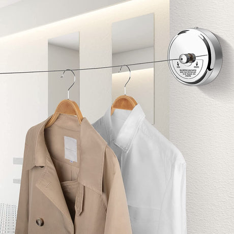 Dolphy retractable round clothesline mounted on a wall with coats hanging on the pulled-out line
