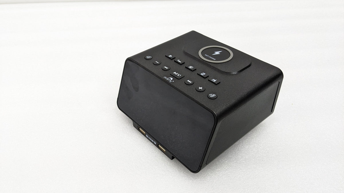 Dolphy black Bluetooth alarm clock dock, angled view of the wireless charging pad and buttons