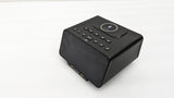 Dolphy black Bluetooth alarm clock dock, angled view of the wireless charging pad and buttons