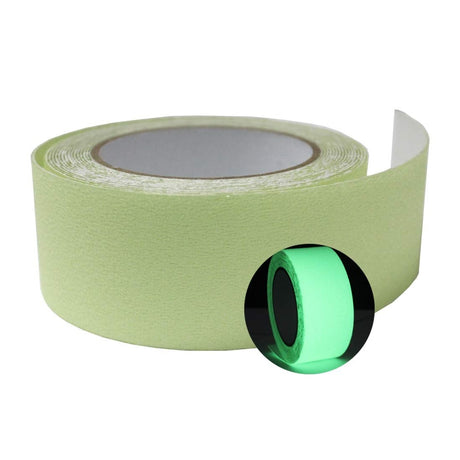 Dolphy glow tape unrolled beside a roll glowing green in the dark