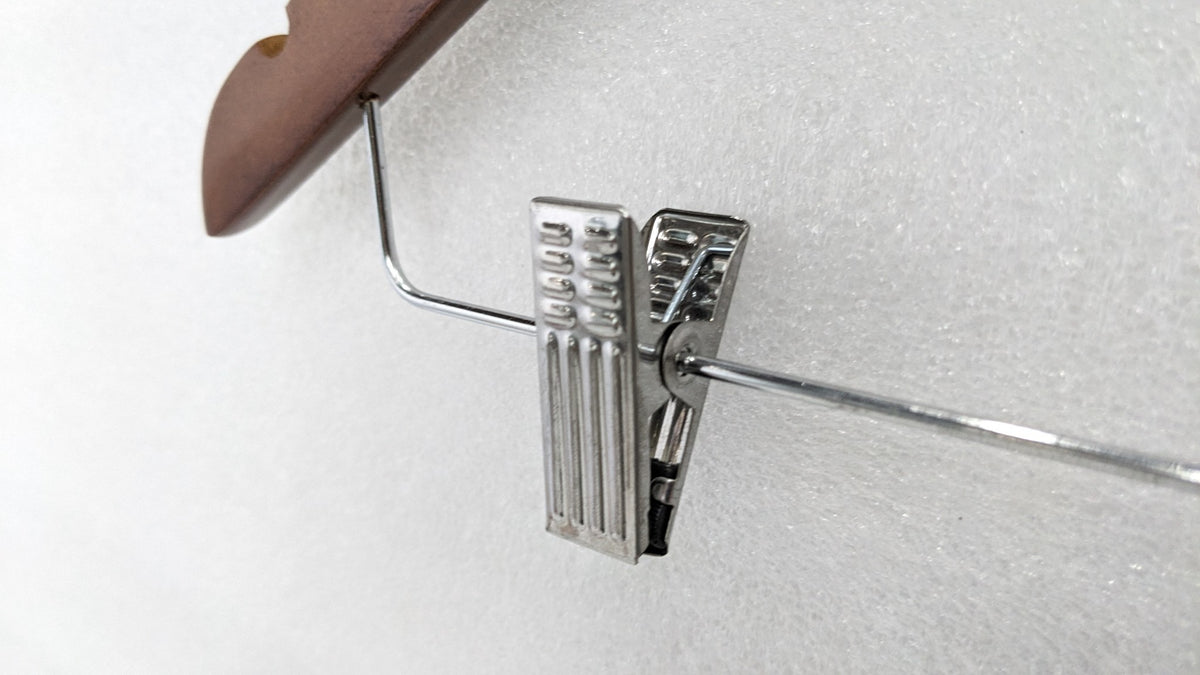 Close-up of the chrome trouser clip on the Dolphy wooden security hanger
