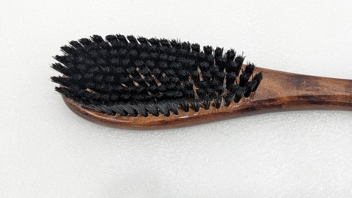 Close-up of the dense black bristles on the Dolphy wooden shoe brush