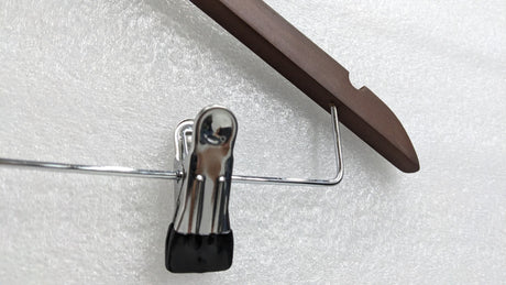 Close-up of the chrome clip with rubber grip on the Dolphy wooden hanger