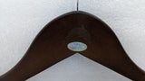 Close-up of the Dolphy logo engraved on the brown timber hanger