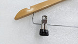 Close-up of a chrome trouser clip with rubber grip on the Dolphy wooden hanger