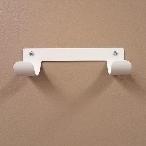 Dolphy white ironing board holder screwed to a wall, ready to hang a T or Y leg board
