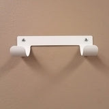 Dolphy white ironing board holder screwed to a wall, ready to hang a T or Y leg board