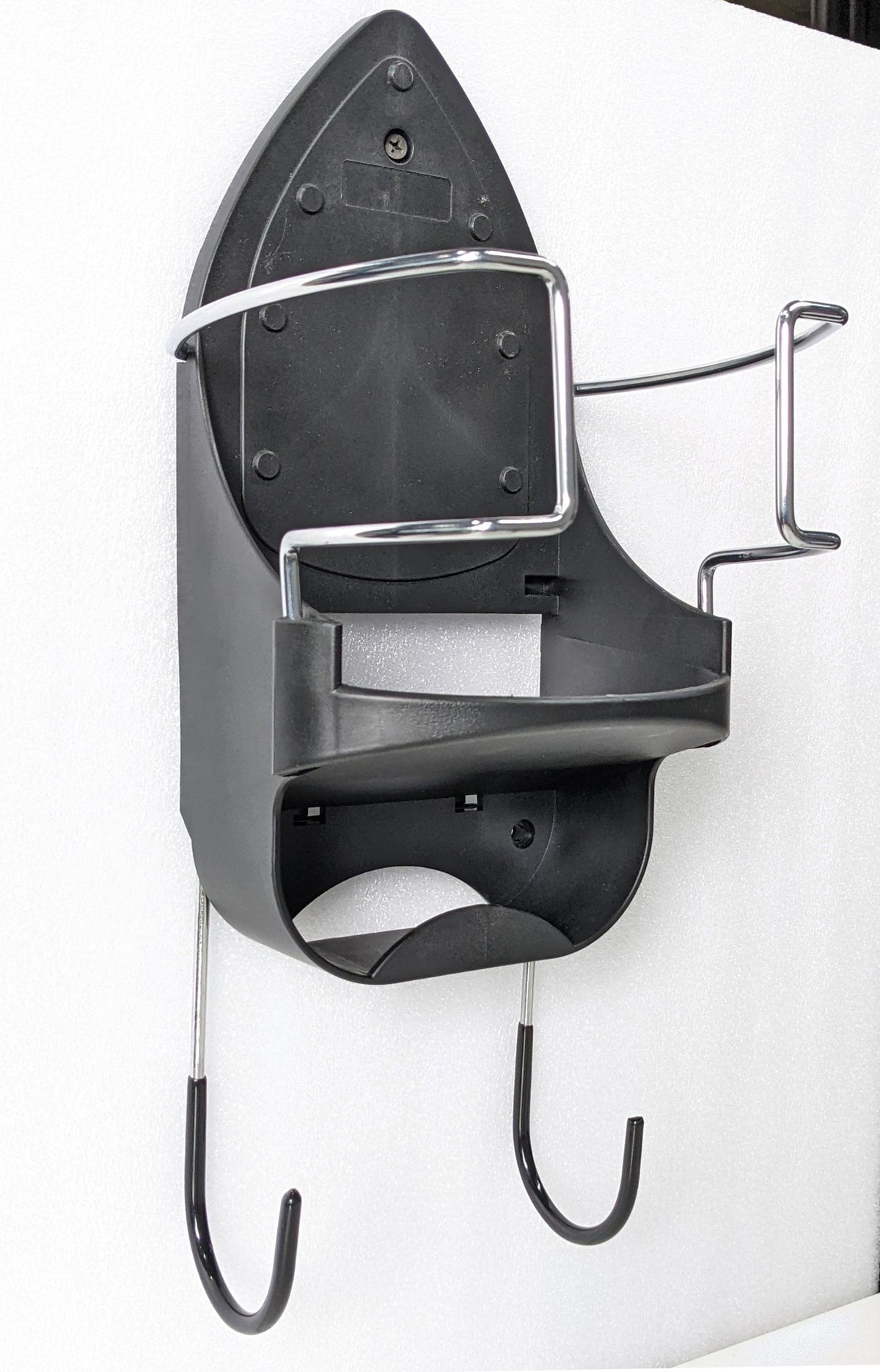 Dolphy iron and ironing board holder mounted on a wall, side angle showing the two board hooks