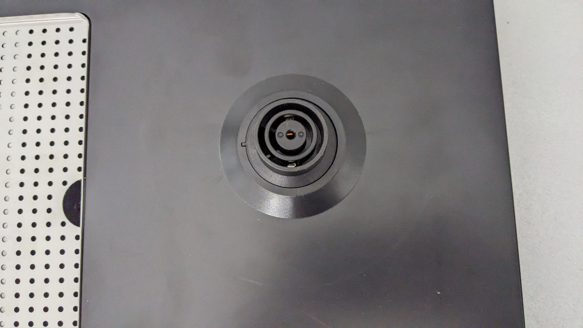 Close-up of the built-in kettle power base on the Dolphy black ABS tray