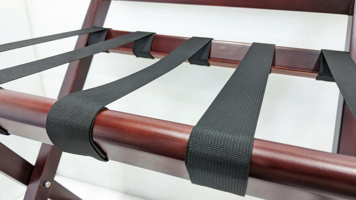 Close-up of the heavy-duty webbing straps wrapped over the Dolphy luggage rack's wooden rail