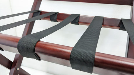 Close-up of the heavy-duty webbing straps wrapped over the Dolphy luggage rack's wooden rail