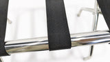 Close-up of a black webbing strap wrapped over the Dolphy luggage rack's chrome rail
