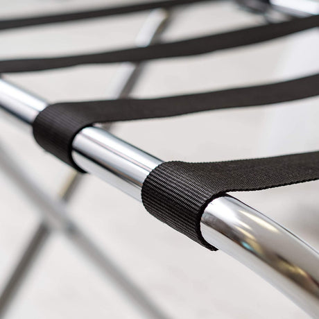 Close-up of the black nylon webbing straps looped over the Dolphy luggage rack's chrome frame