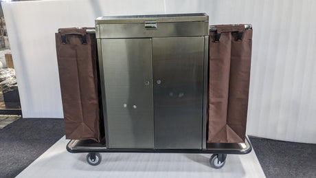Dolphy stainless steel housekeeping trolley with two brown linen bags and lockable doors