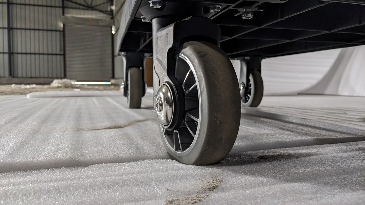 Close-up of a swivel castor wheel on the Dolphy housekeeping cart